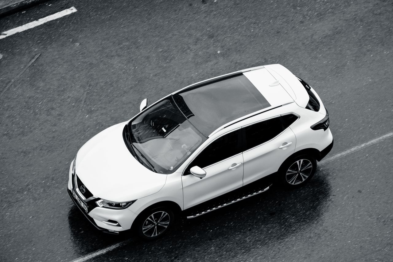 A white SUV is seen from above cruising along the wet streets of Istanbul, Turkey.